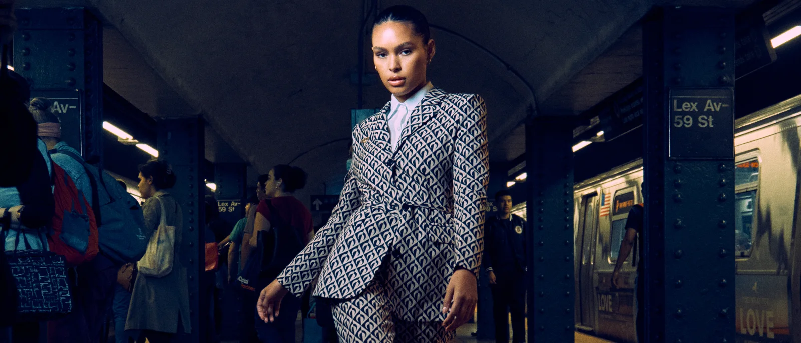 A model in patterned tailoring on a New York subway platform.