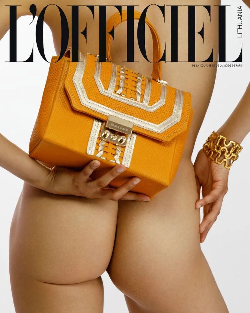 L’Officiel Lithuania page featuring a yellow handbag and gold accessories.